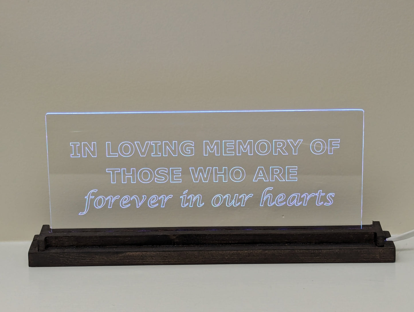 Evoke cherished memories with our custom etched acrylic memorial LED light. A thoughtful and enduring tribute made with high-quality materials for lasting remembrance. Etched acrylic displayed in dark wood base.
