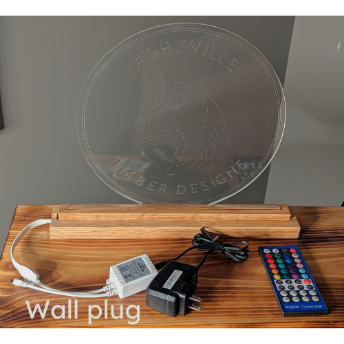 Oak wood base comes with options for power source. Shown here is the standard US wall plug and RGBW remote control to change the lamp color and brightness.